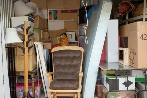 stuffed storage unit with chairs mattresses household goods