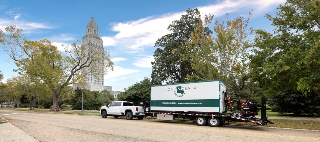 load geaux baton rouge portable storage container being delivered state capitol in background
